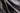 A close-up of draped dark gray fabric with soft folds and a smooth texture.  #color_charcoal