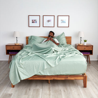 Girish is sleeping in our 100% Eucalyptus Sheets in Sage green||#color_sage