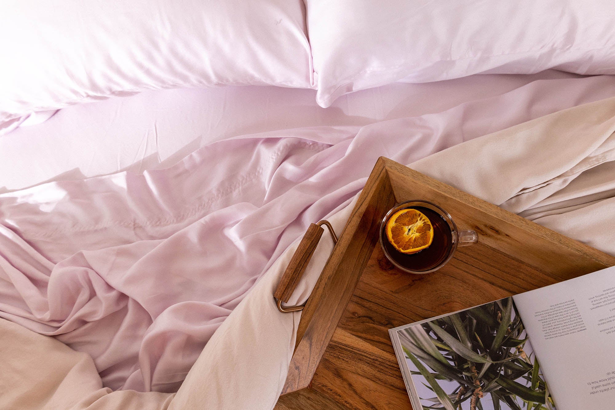 Orchid Ice Eucalyptus Sheet Set with a tray of tea and a book||Orchid